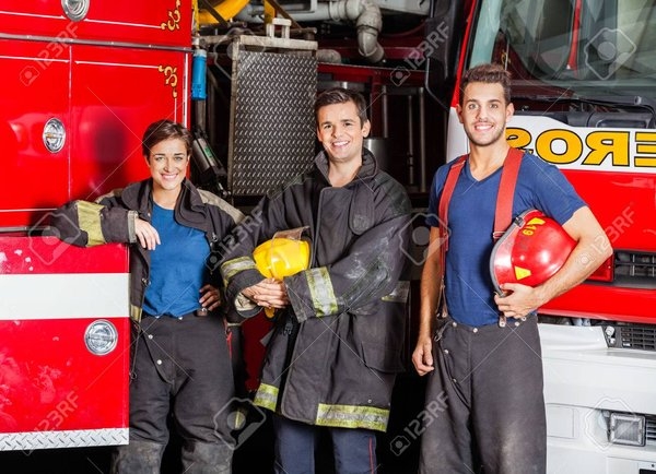 43431875_portrait_of_confident_young_firefighters_standing_against_trucks_at_fire_station_1.jpg